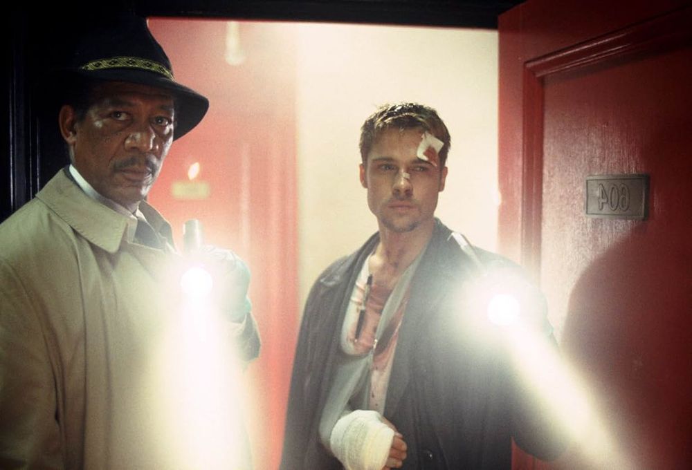 Image from SE7EN (1995).

Morgan Freeman's Somerset and Brad Pitt's Mills shining their flashlights into a room.