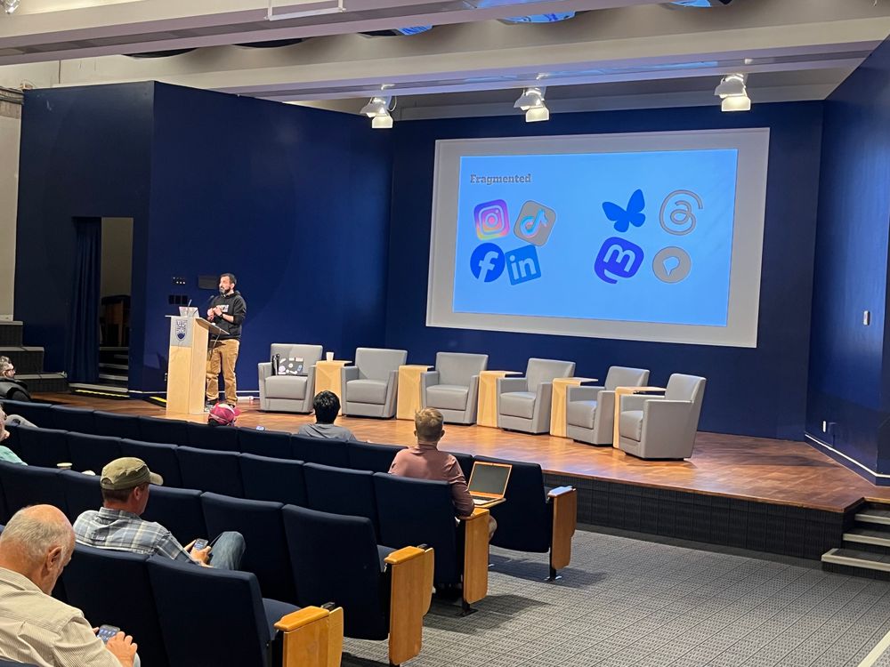 Anuj presenting - slide which shows closed networks IG, TikTok, LinkedIn, Facebook

And the open side are logos for Bluesky, Threads, Mastodon, Pixelfed