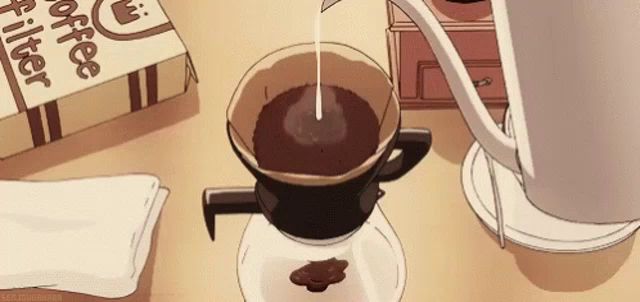 a cup of coffee is being poured into a paper filter