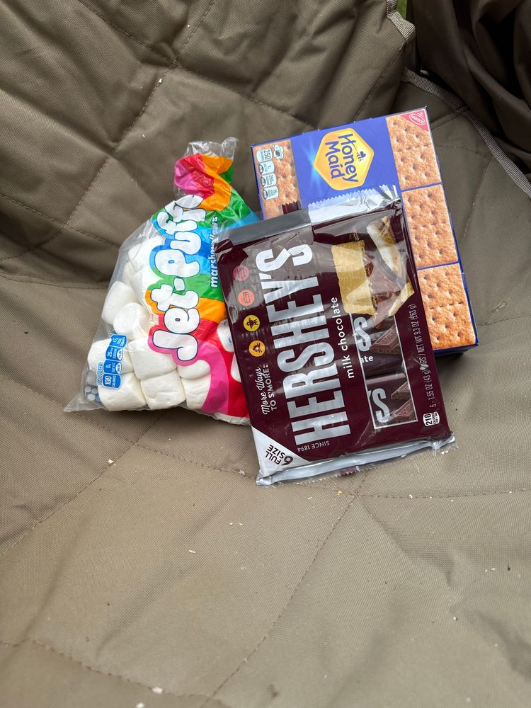 Marshmallows, Hershey’s chocolate bars and Honeymaid graham crackers sit in a pile.