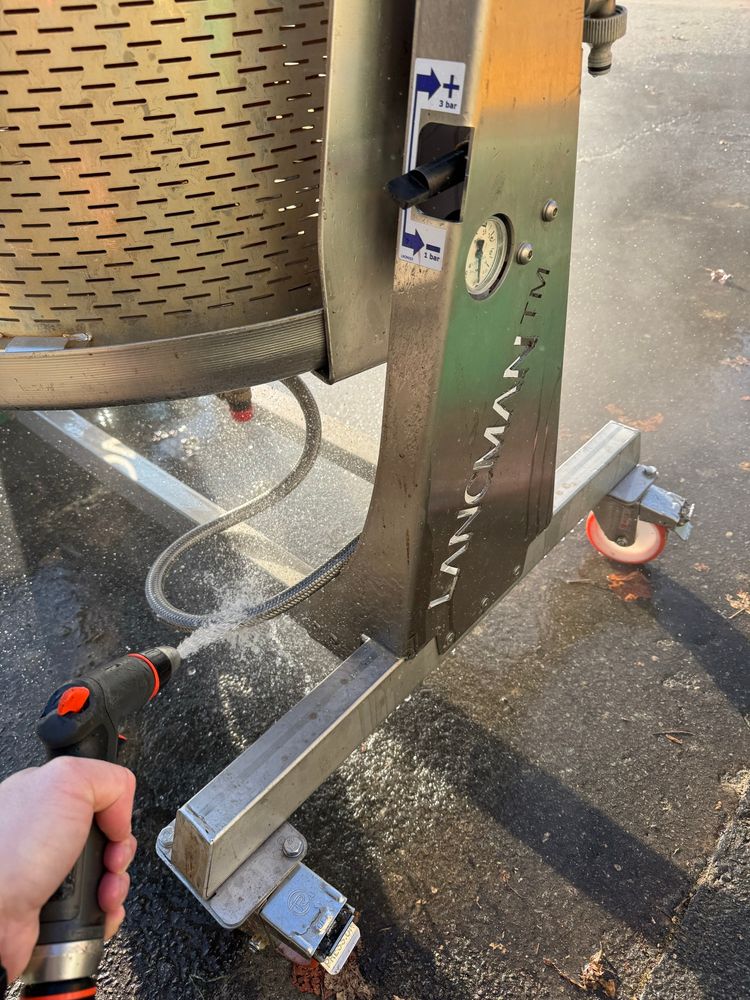 Spraying the feed hose of our hydro press with warm water. The feed hose clearly had water still in it that froze, stopping the press from functioning. 
