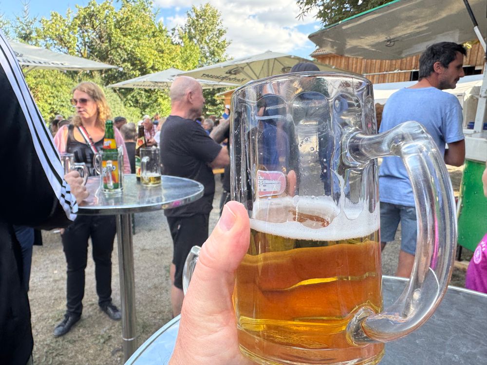 A glass of beer and the festival crowd in the background 