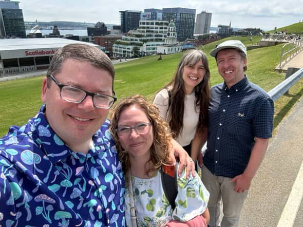 Selfie of Lukas and Annie (creators of A Little to the Left) with popular streamers PapaPupp and Pokie, with the city of Halifax seen in the background