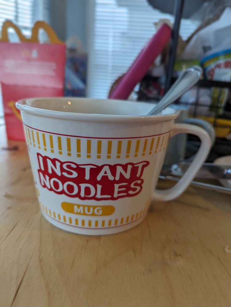 A bowl-sized mug decorated in the style of an instant noodles cup, full of delicious instant noodles (not pictured)