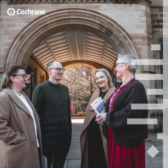 Four individuals are engaged in conversation near the arched entrance of a building. One person holds The Cochrane handbook. The Cochrane logo appears in the upper left corner