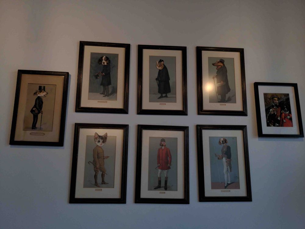 Portraits of lords and ladies have been modified with cat and dog heads.