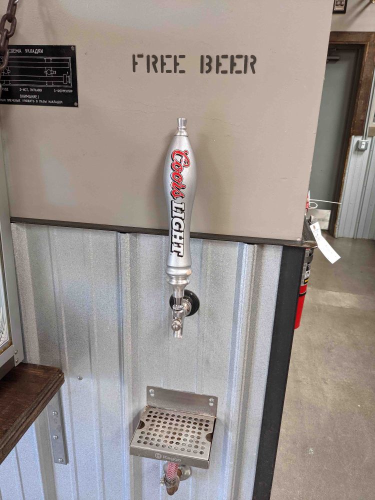 Water fountain station operates with a Coors Light tap. Sign above tap says "free beer."