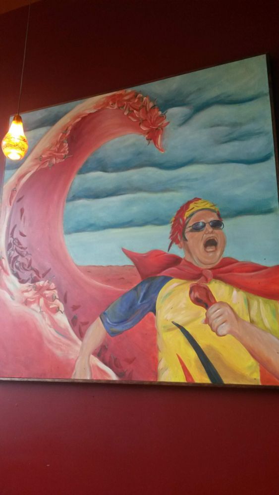 Painting of a person in a cape with a drumstick in hand screaming and fleeing from a tidal wave of chile peppers.
