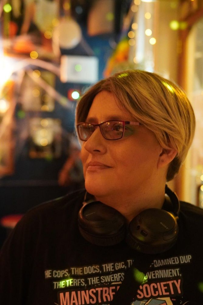 Photo of me taken at a gig,  looking off into the venue