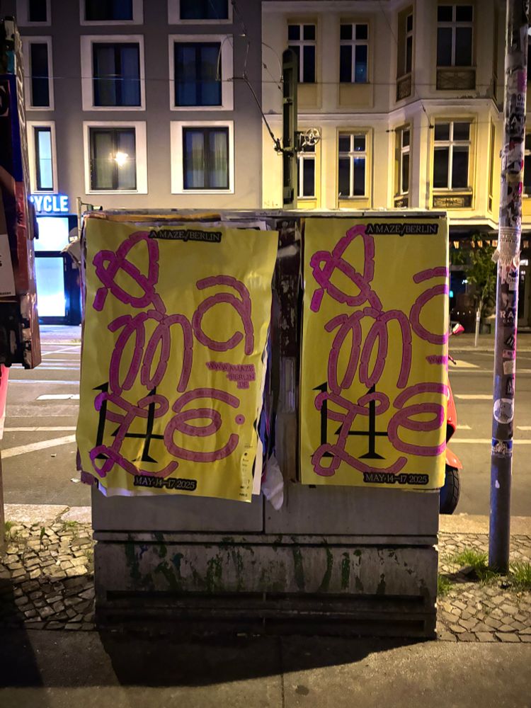 Photo of two posters for the AMAZE 2025 festival in Berlin.