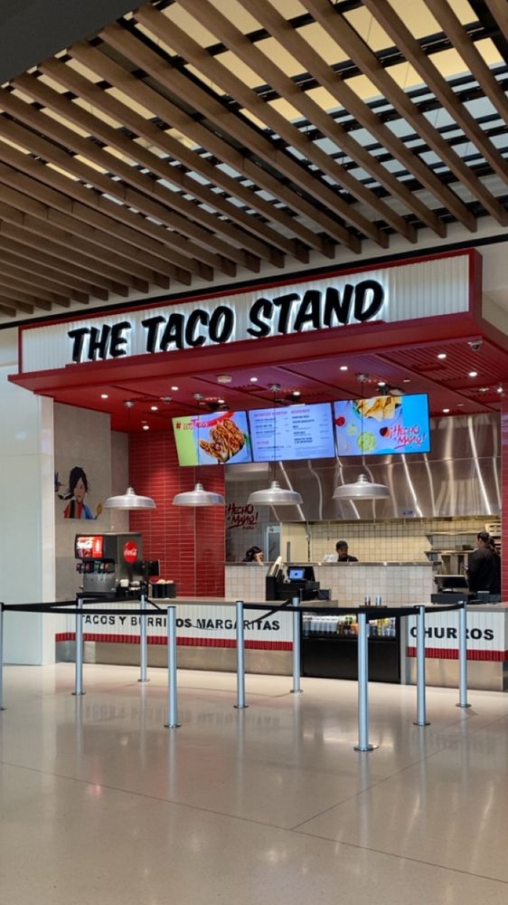 A food court storefront restaurant called “The Taco Stand”.