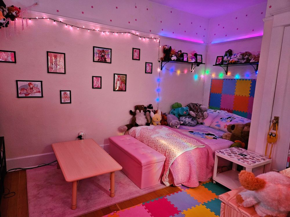 Photo of a bedroom with a lot of pastel pink, lights and stuffed animals 