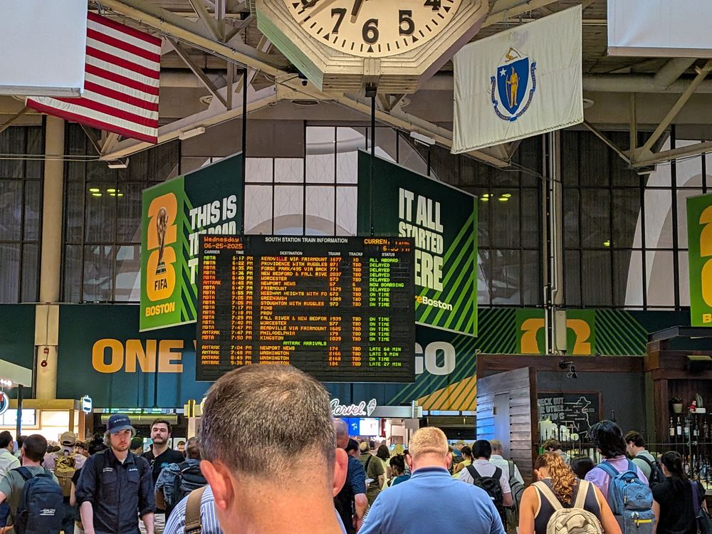 The departures board at South Station, with most upcoming and should have departed trains listed as "delayed"