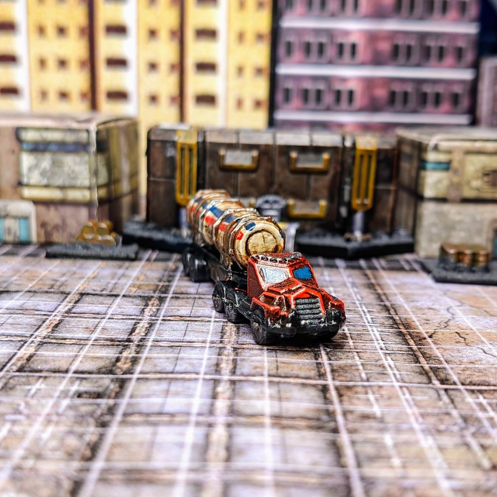 A picture of a 6mm scale truck (front view). The truck has a red engine and a tank trailer.