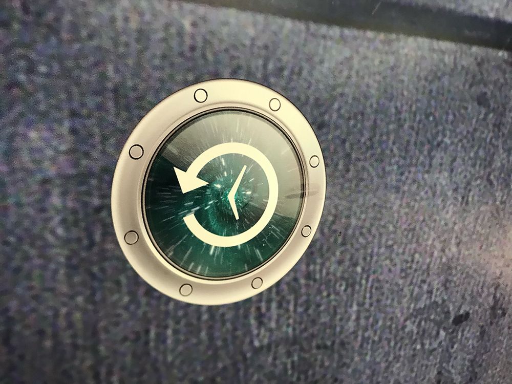 A close-up of the Apple Time machine icon sticker on the TARDIS door background vinyl. It's an older version of the time machine icon which suits me just peachy.
