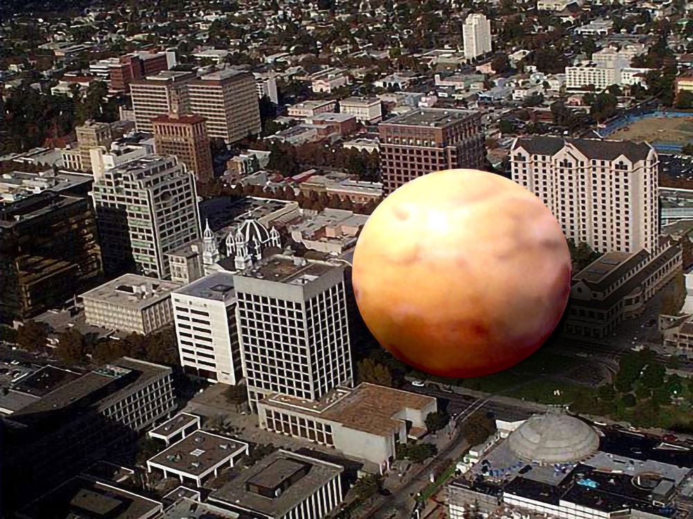 An artists representation of the planet mars as it passes closest to earth just grazing chavez plaza in downtown san jose.