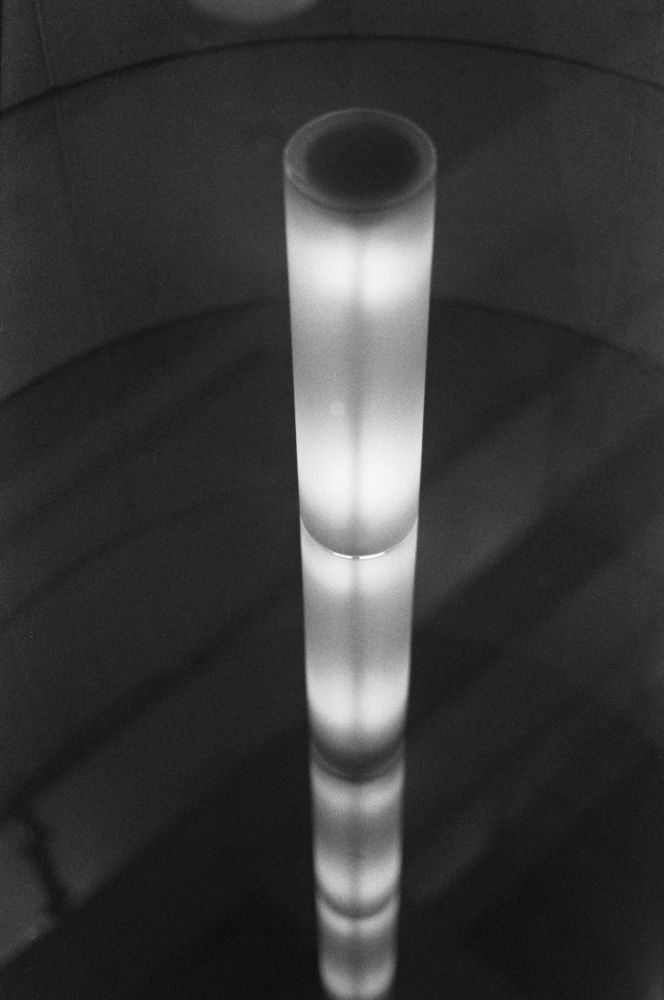 A black and white abstract photograph: glowing white vertebrae bisect a canvas transected by long shadows as the quiet roar of an echoing depth falls below (or does it soar above)? Lost, again. Most likely somewhere.