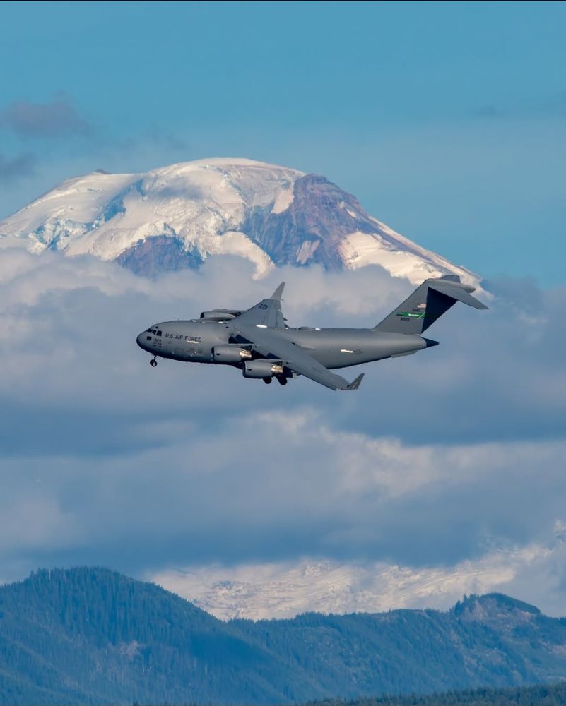 United States Air Force cargo transport airplane. Snow covered mountain in the background. Airmobility McChord Airforce Base