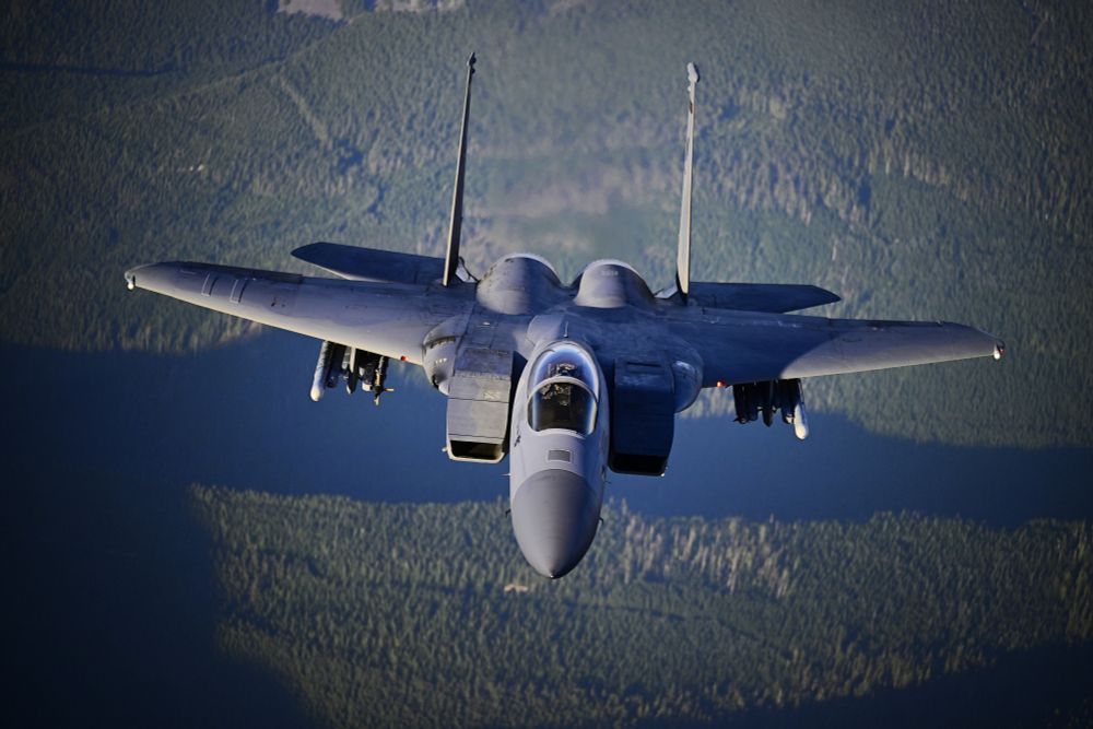 an f-15 Eagle in flight from above over a forested area near mount hood. USAF #fighterpilot #topgun #nikon #jet