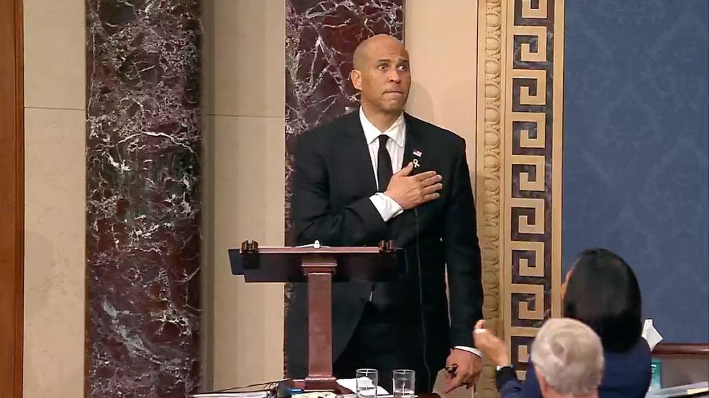 Senator Cory Booker standing on the Senate floor after breaking the record for longest speech in Senate history.