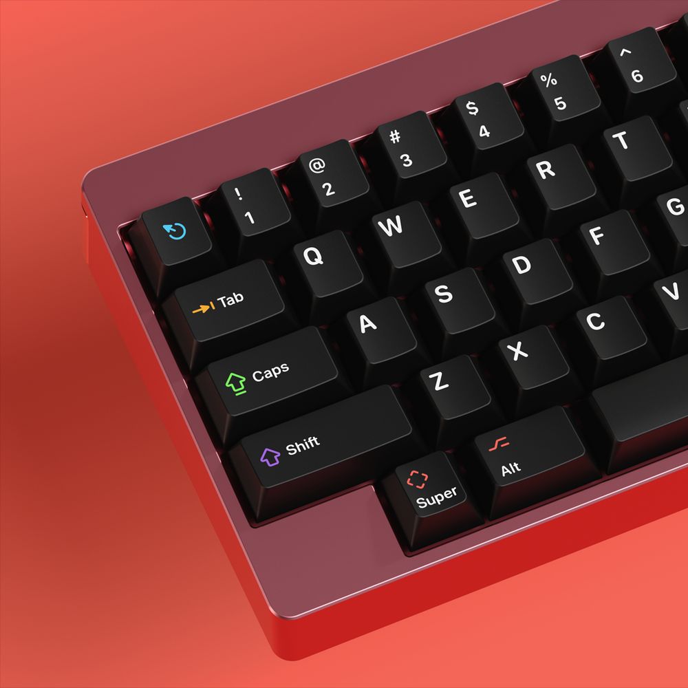 An angled red metallic mechanical keyboard with a 60% ‘Happy Hacking Keyboard’ layout, with black keycaps and white legends, with several icons in bright colours