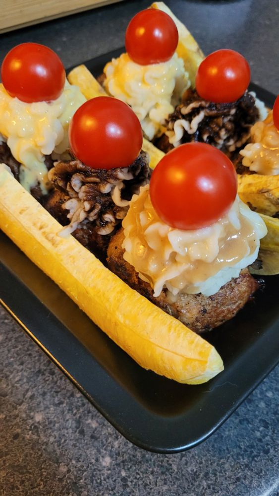A dish with what certainly resembles a banana split sunday on it complete with a split banana, three scoops of ice cream, whipped cream, a trio if sauces, and cherries on top