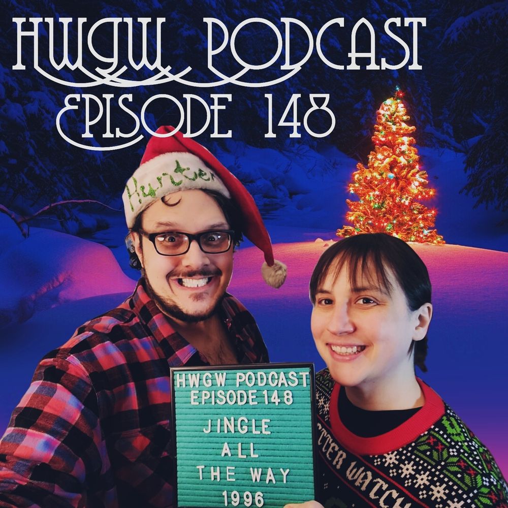 Allison and I (she is wearing a holiday sweater, I am wearing a Santa hat with ny name on it) both forcing smiles in front of a lit Christmas tree in a snowy wood. Allison is holding Marquee Mark, the podcast's teal, felt, marquee mascot who reads "HWGW Podcast, Episode 148: JINGLE ALL THE WAY (1996)"