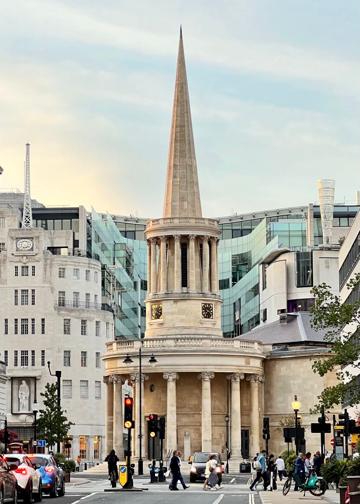 A rounded church entrance with a narrow round drum topped by a thin, tall steeple.