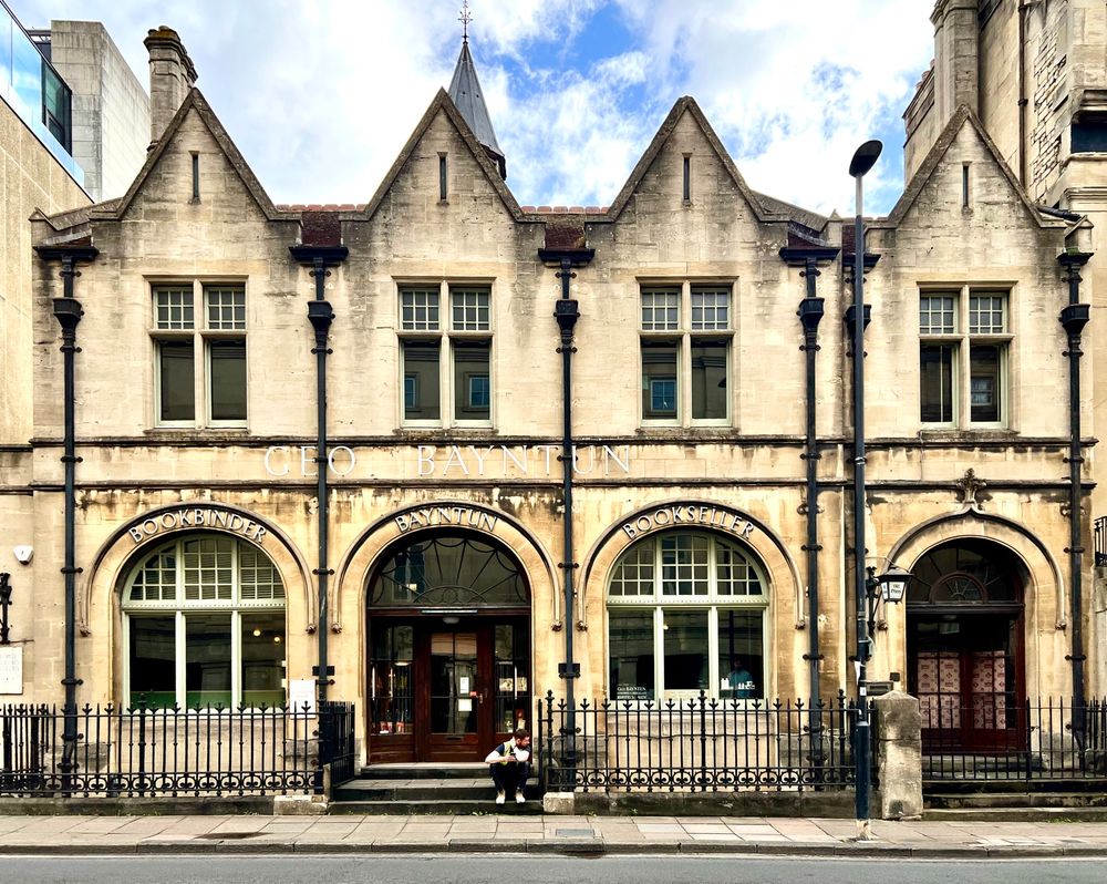 A stone building with four arches underneath four gables.