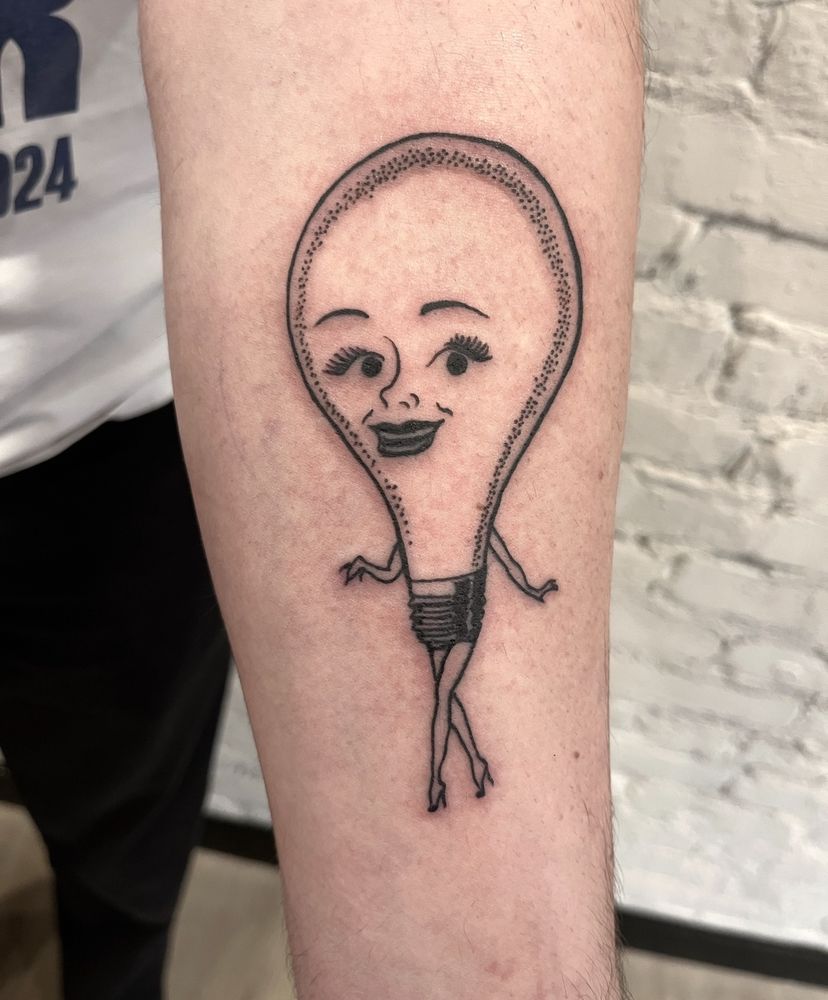 A tattoo on a forearm of an anthropomorphized light bulb lady 