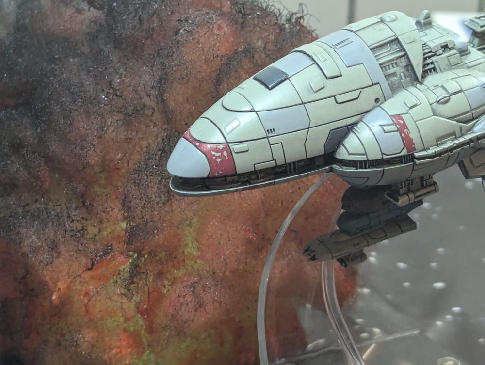 Void Admiral with Armada models, a tabletop with Star Wars battleship Miniatures, a capital ship cruises close to a nebula. 