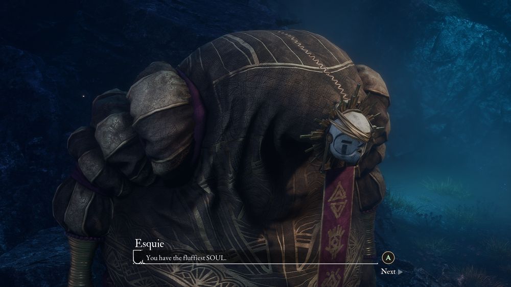The picture is a screenshot from the video game Clair Obscur: Expedition 33, and shows a large, hunched, rotund character dressed in golden coloured clothes with puffy sleeves and a white mask that resembles the sun. There is a subtitle showing what the character is saying which says the character's name, Esquie who is saying 