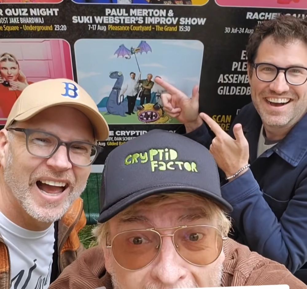 Rhys Darby, Leon Kirkbeck and Dan Schreiber (aka The Cryptid Factor) standing in front of their modestly sized poster at the Fringe