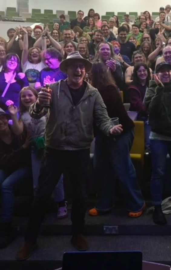 Rhys Darby damp, post popping champagne 