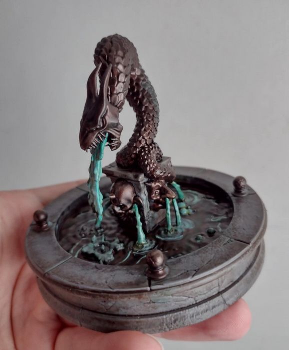 A miniature Fountain with a dragon statue in the middle spewing water