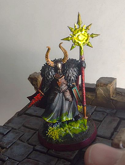 Chaos Sorcerer Lord Warhammer Miniature all painted. In the lower right of the picture is my thumb which I've grown very fond of over the years. I just think it's neat.