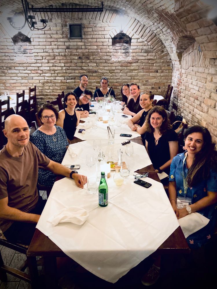 A group of people sitting at a table at a restaurant
