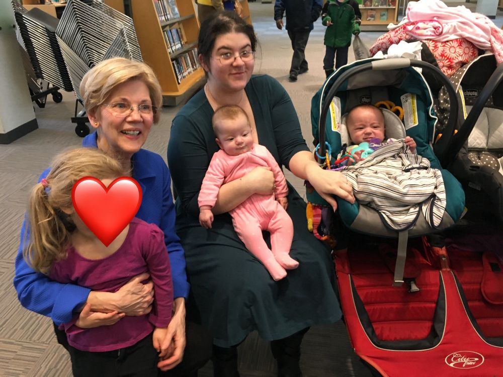 Picture of Senator Elizabeth Warren with three children and a constituent. 