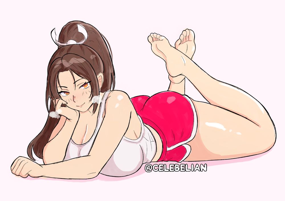 Mai Shiranui lounging in a tank top and dolphin shorts.