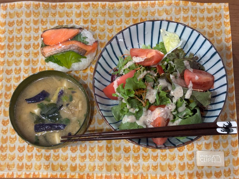 大きめボウルに入ったサラダ、茄子の味噌汁、鮭の切り身と大葉ののったおにぎり
スピノサウルスプリントのお箸