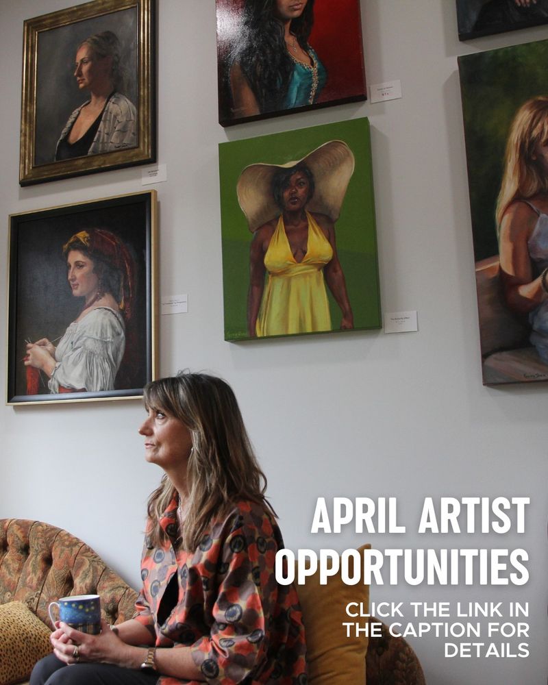 An artist sitting with her profile to the camera for a portrait in front of several of her portraiture paintings that are hanging on a white wall. Text says "April artist opportunities. Click the link in the caption for details."