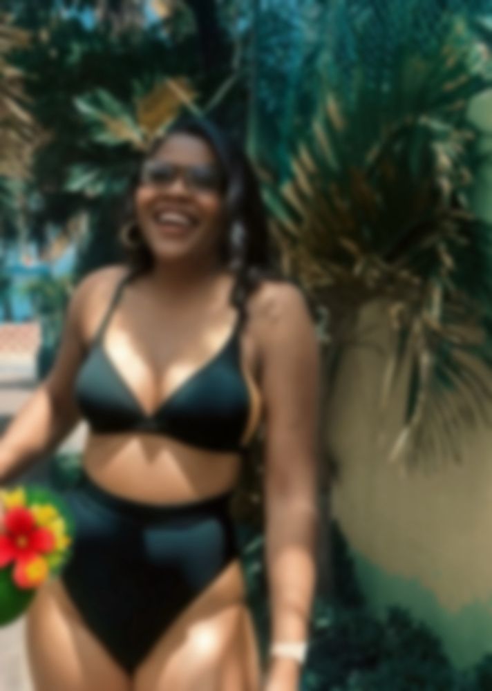 In peach and black swimsuit (blurred)