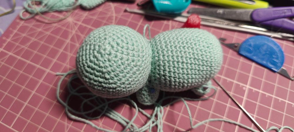 half finished crocheted bulbasaur from top down