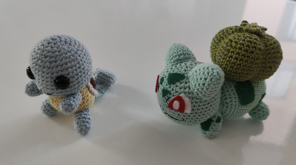 a crocheted squirtle and  bulbasaur 