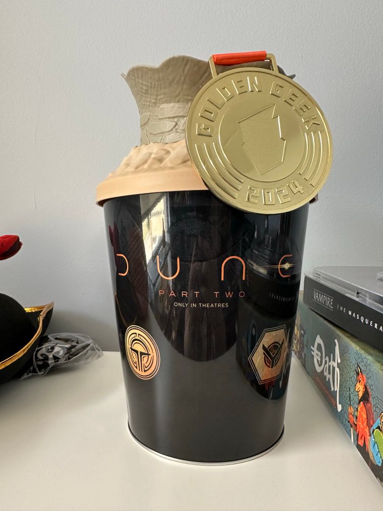 My Golden Geek medal hanging from a Dune popcorn bucket. 