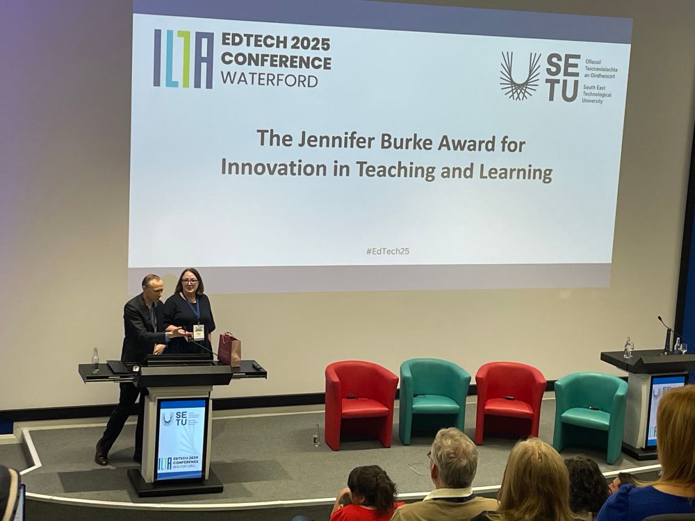 The auditorium at edtech with Eamon and Alison on stage. 