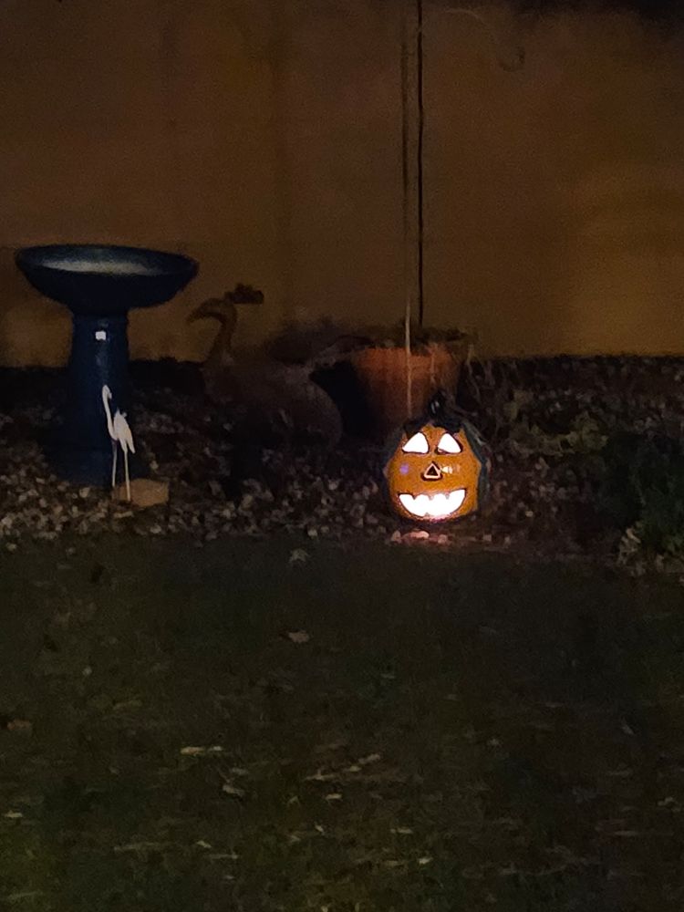(Crappy) photo of a little jack o'lantern in the dark.