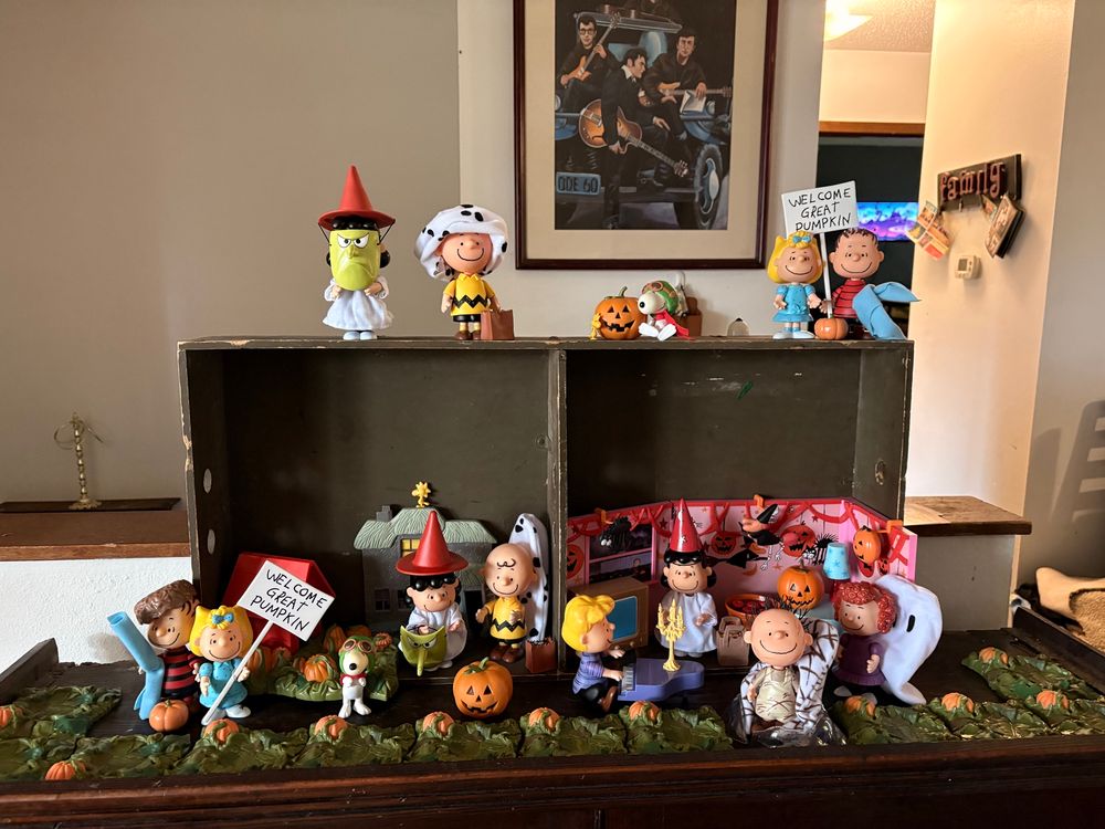 An It’s the Great Pumpkin play set. Shown are figures of Linus with his blanket and signs welcoming the Great Pumpkin, Sally standing with him, Lucy in her witches costume, Charlie Brown with his ghost costume, Schroeder playing his piano, PigPen in a cloud of dust, Frieda with her naturally curly hair, the World War One Flying Ace, Woodstock, and a bunch of pumpkins (it is a sincere pumpkin patch after all) 