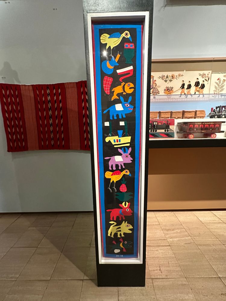 applique on fabric depicting a bunch of little animals in bright colors, forgot what country this was from