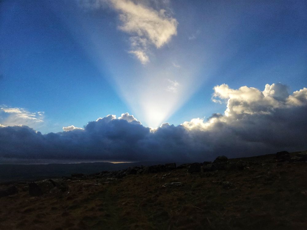 A spotlight coming from behind the clouds at Norber. 